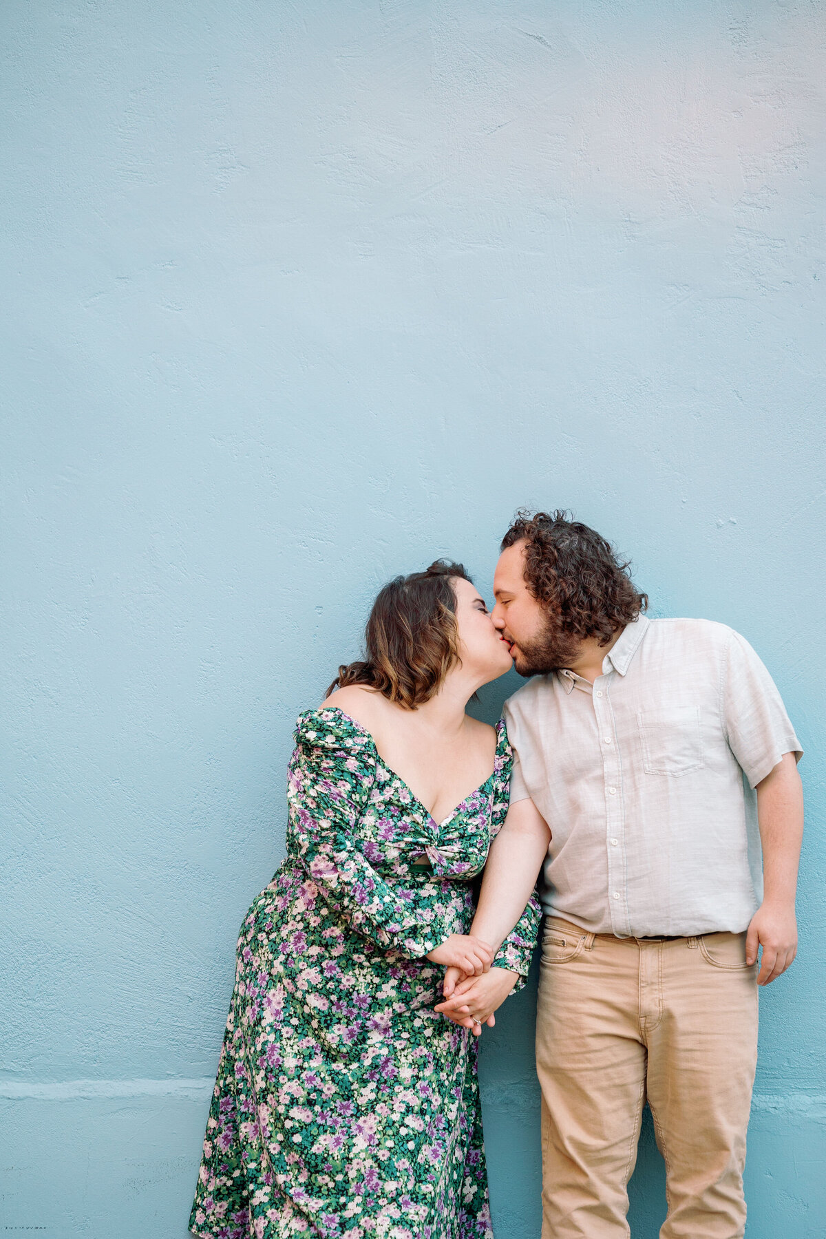 A couple holding hands and kissing