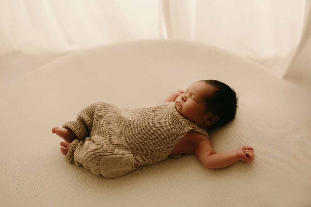 Newborn lying on cream blanket during Nashville TN studio newborn photography