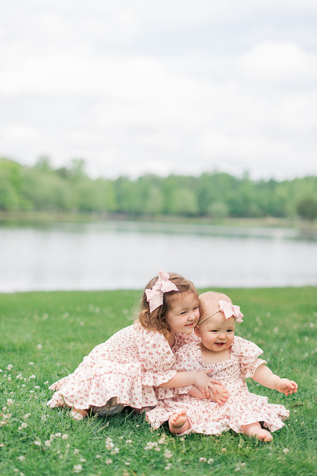 Sisters laughing together during family session