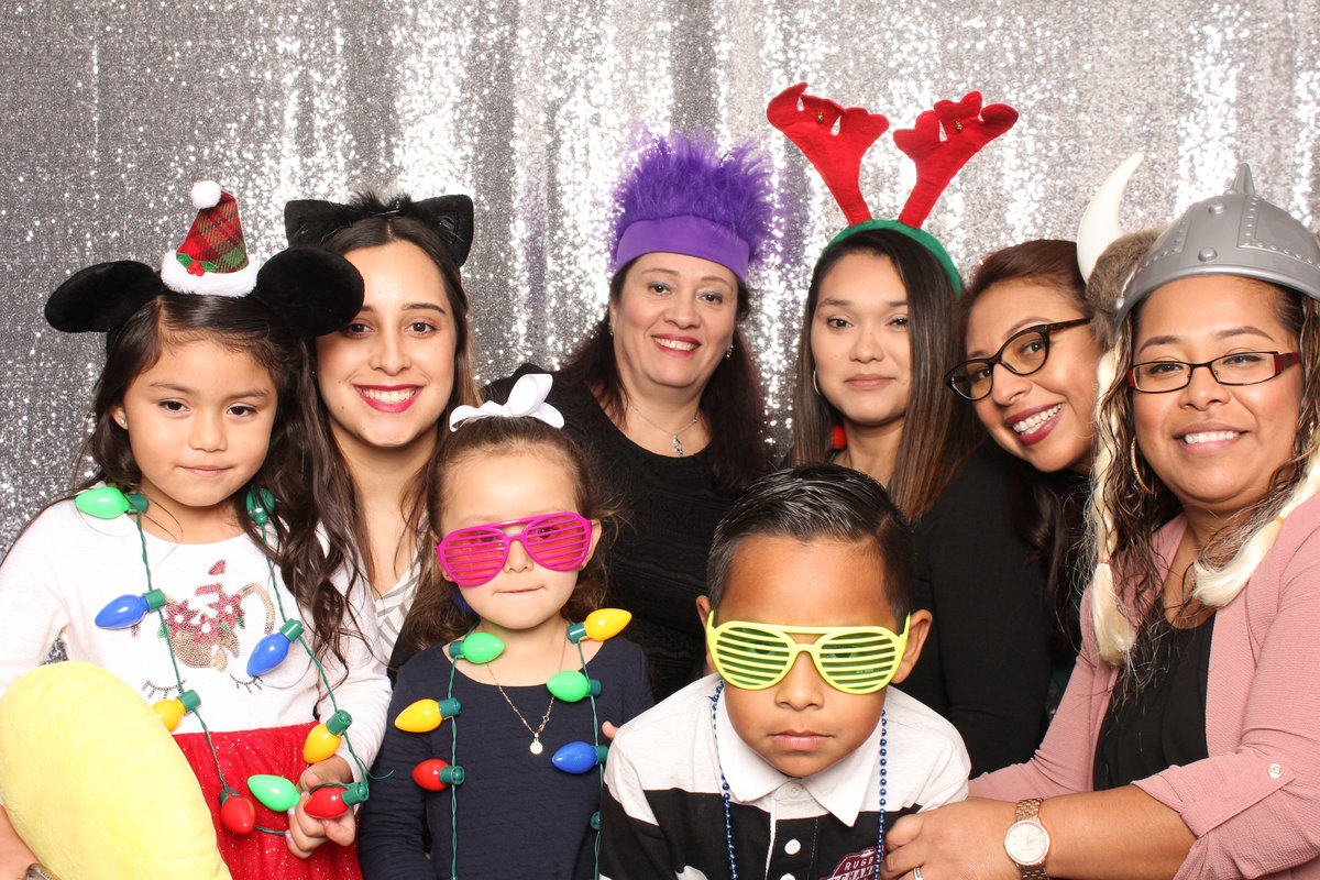 Group on moms and kids pose in a photo booth