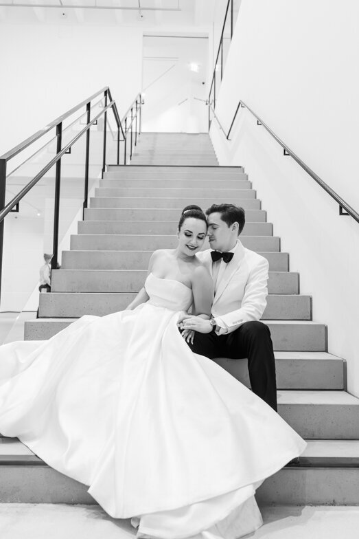 bride and groom sitting on stairs at the Museum of Contemporary Art San Diego wedding