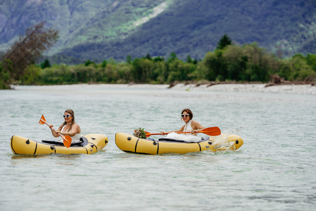 romantic couple in wedding dresses kayaking Soča River