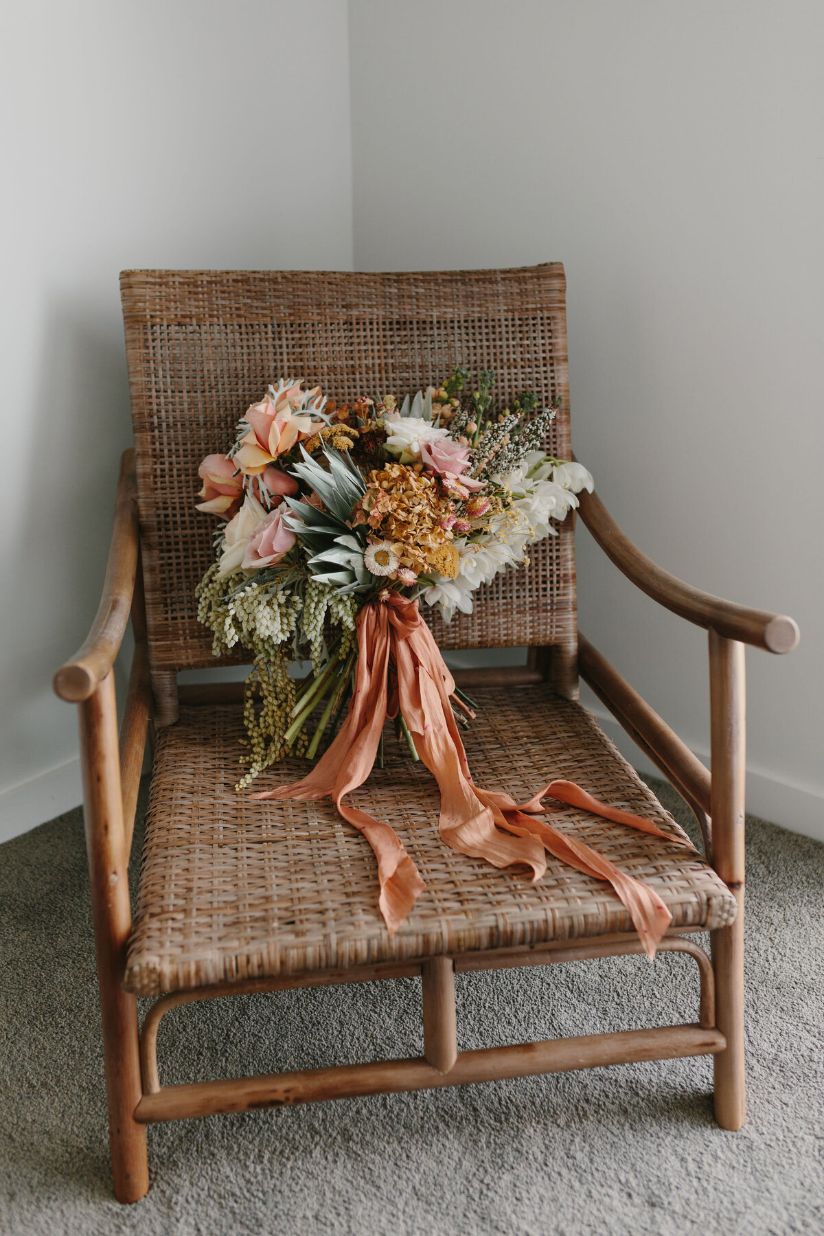 The Vase Floral Co - bridal bouquet sits in chair