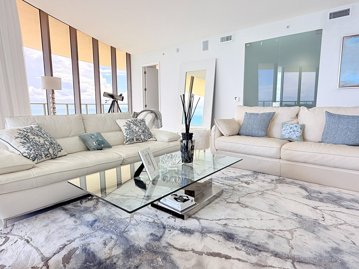 Expansive luxury living room with 10ft glass walls and direct ocean views at St. Regis PH-888