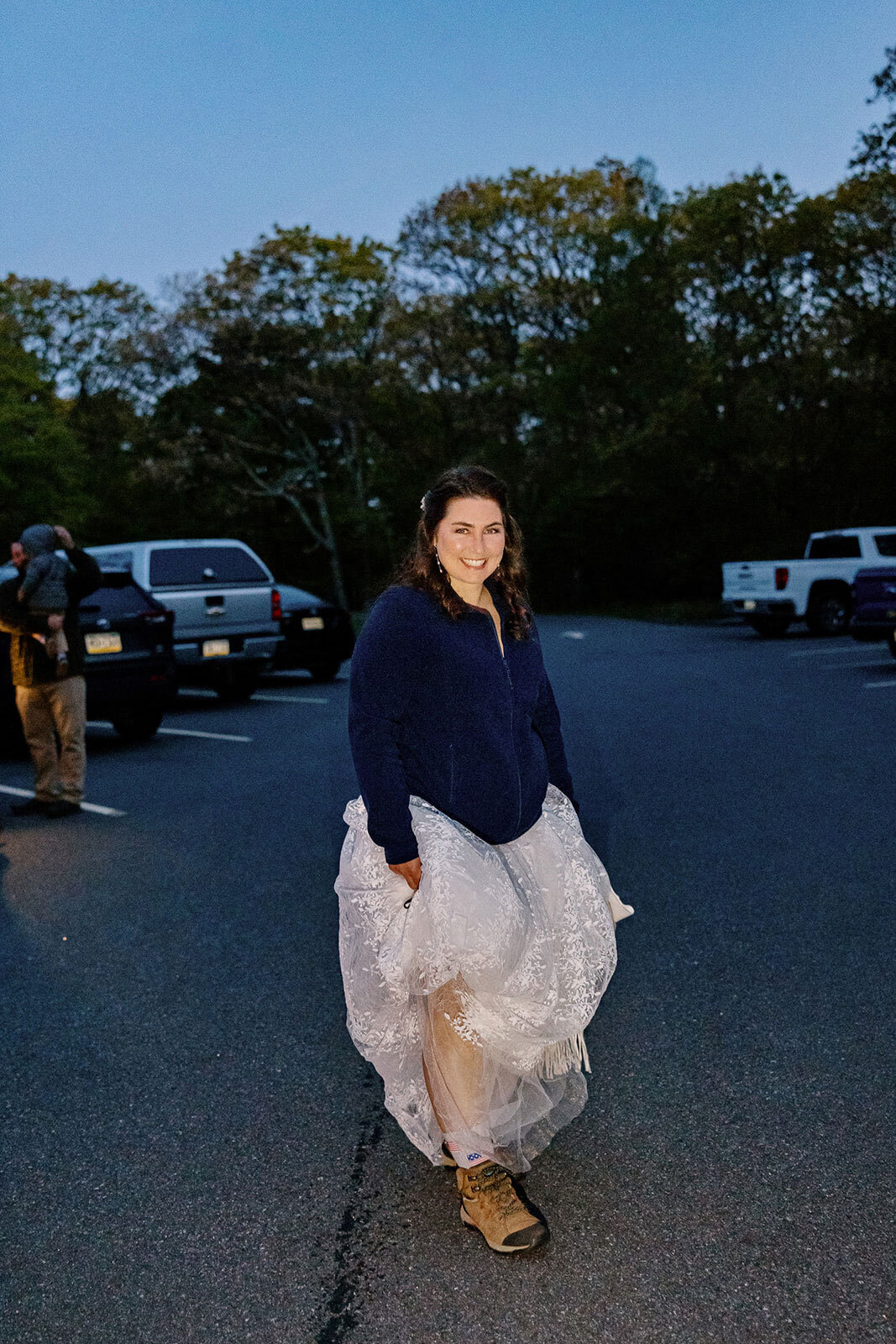 A bride stands in the parking lot at Stony Man before the sun has risen waiting to hike up to the summit for her ceremony. 