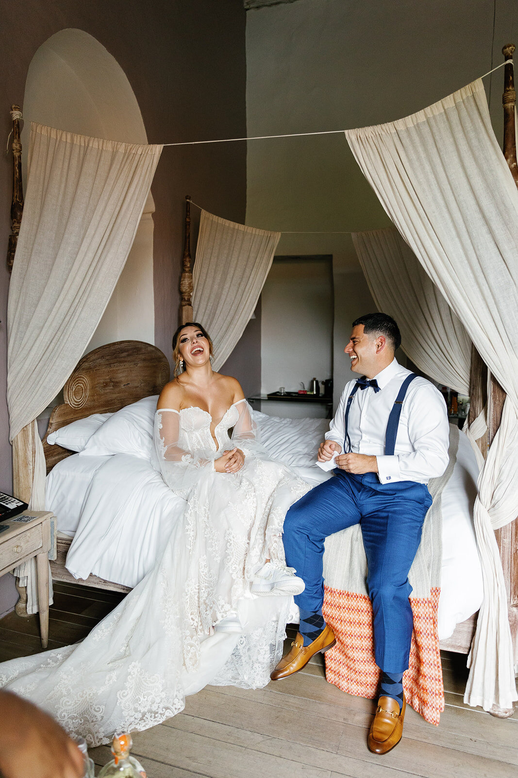 A joyful moment as Victoria and Daniel share a laugh in their Cartagena Colombia wedding suite.