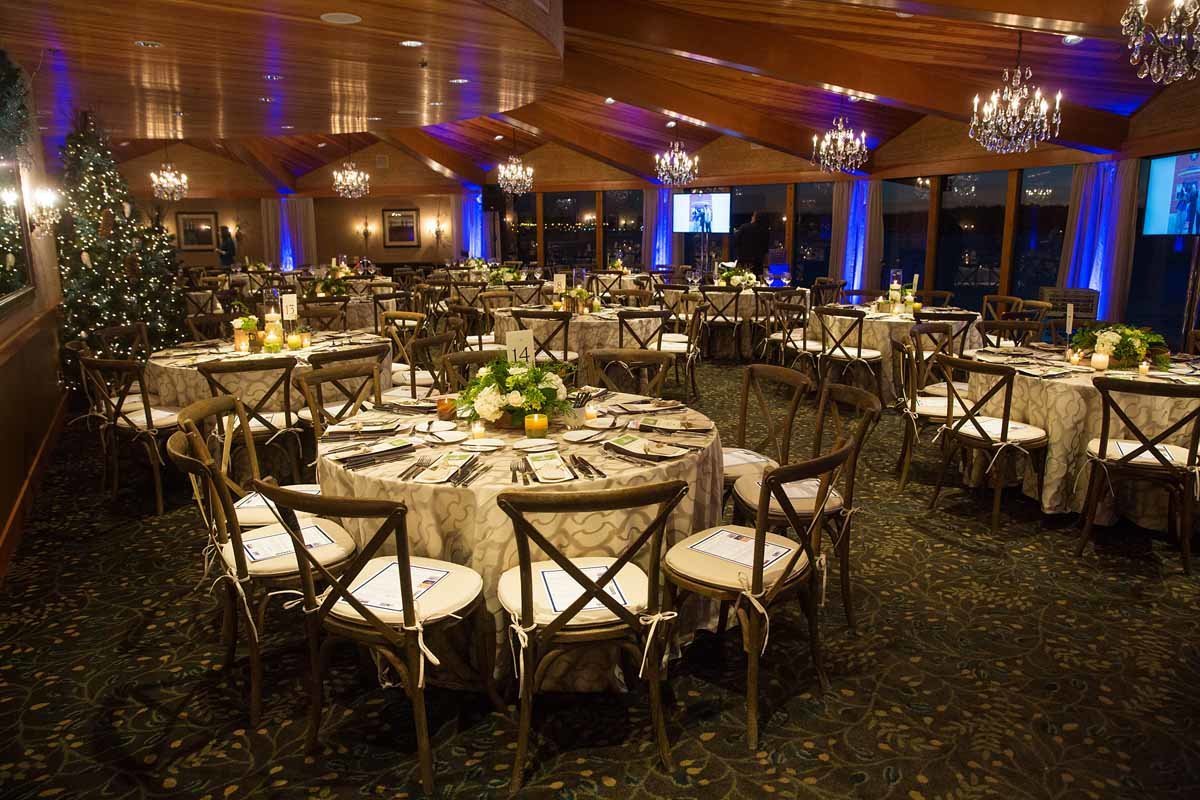 Marchawn Lynch foundation fundraiser at Edgewater Hotel Seattle with round tables and vineyard chairs
