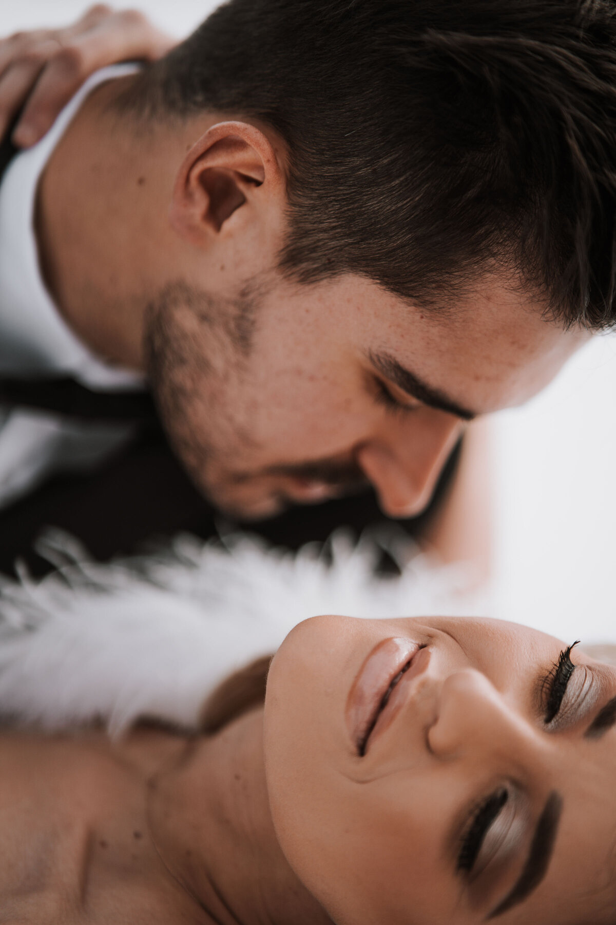 Groom dips Bride backward and kisses her neck zoom in shot showing gorgeous bridal makeup captured by Idaho Falls Wedding Photographer