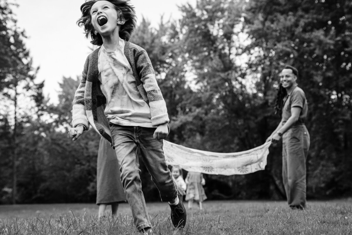 Kids run around and have fun with parents outdoors.