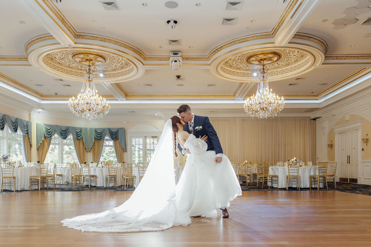 Eagle Oaks Golf Club | Groom dipping bride for kiss in ballroom | Farmingdale, New Jersey