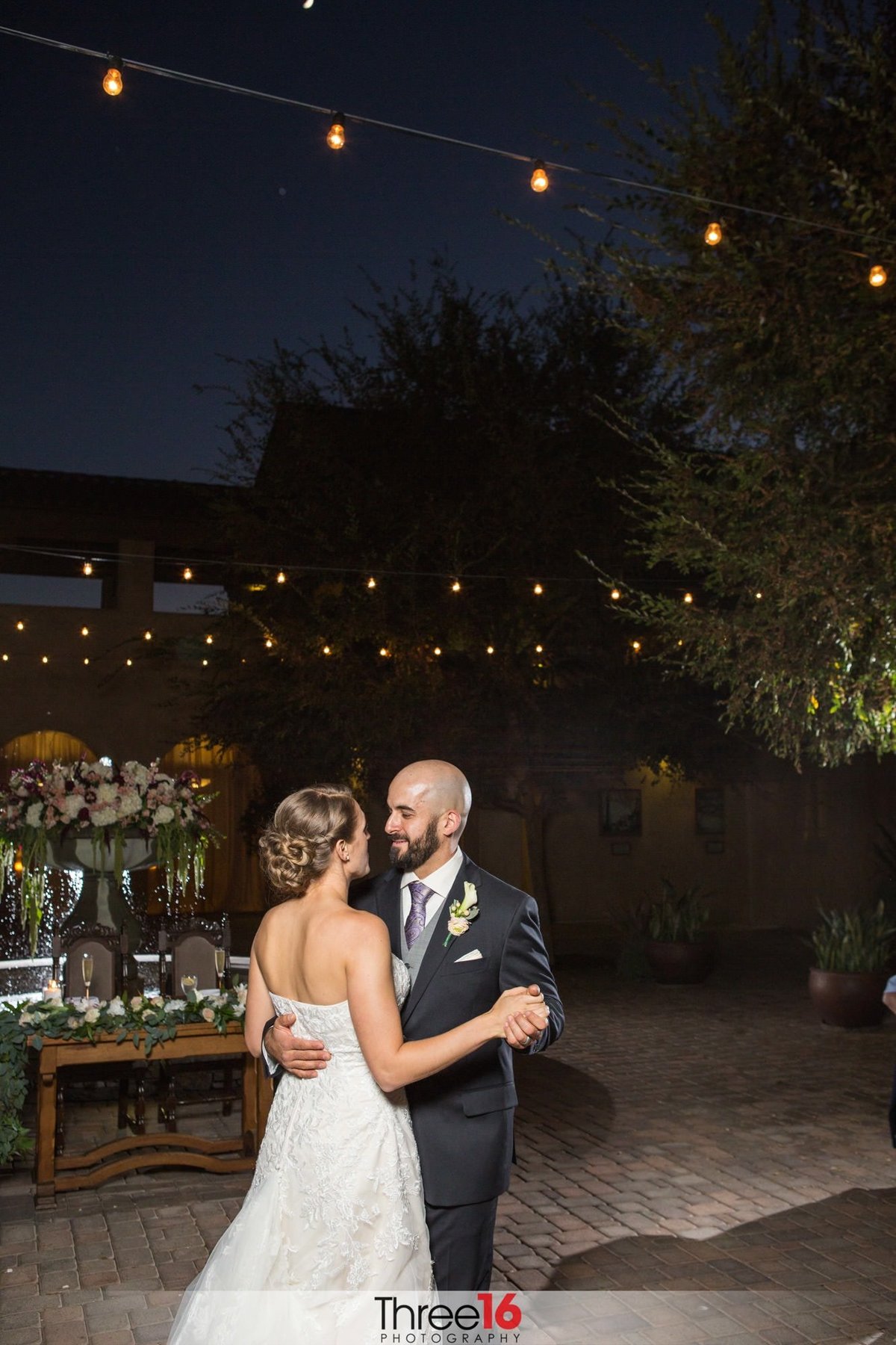 Bride and Groom dance their first dance under the dark sky night