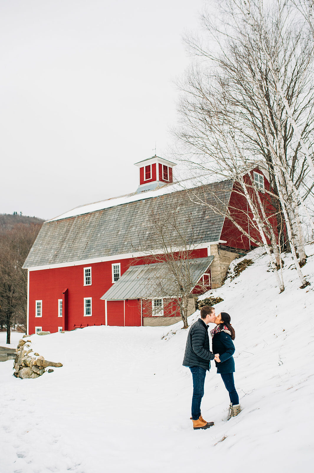 vermont winter engagement with couple at farmhouse inn red barn vermont snow