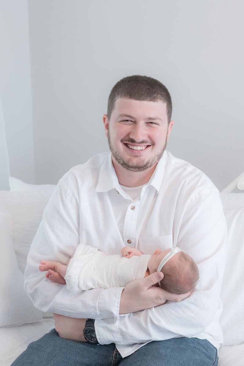 Dad holding newborn baby in Savannah ga photography studio