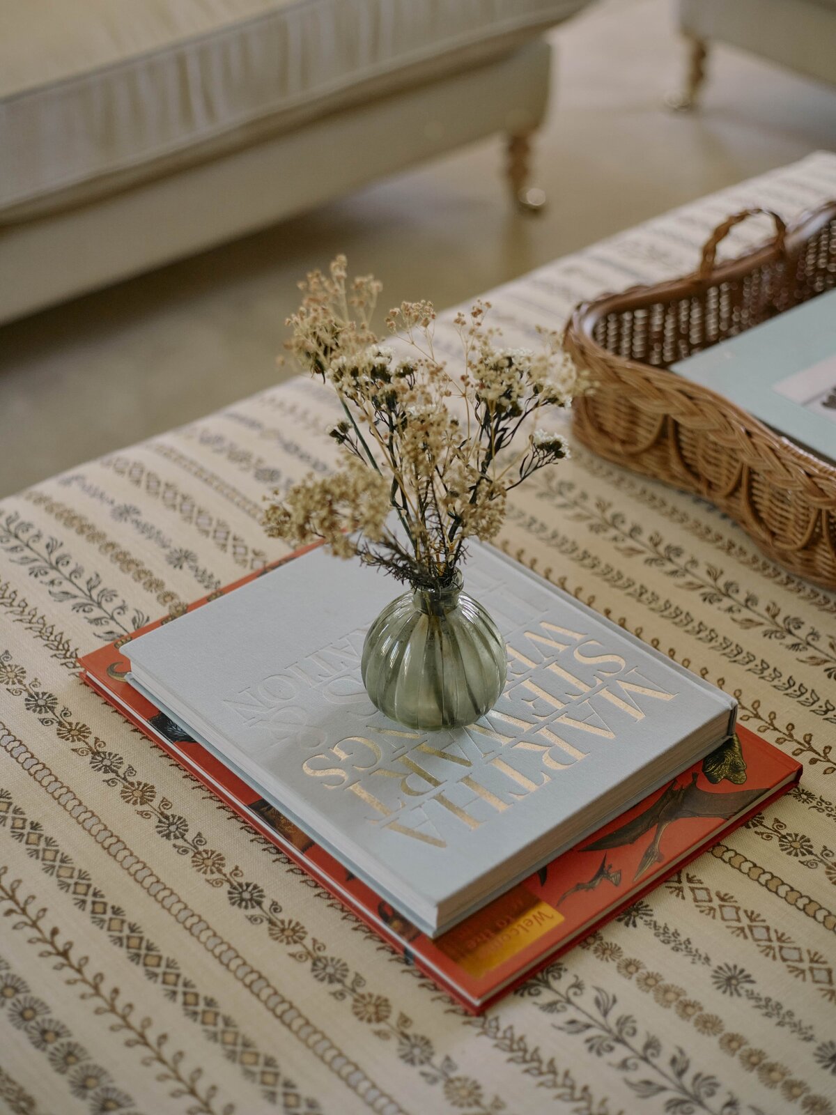 Detail shot of ottoman with coffee table books on top
