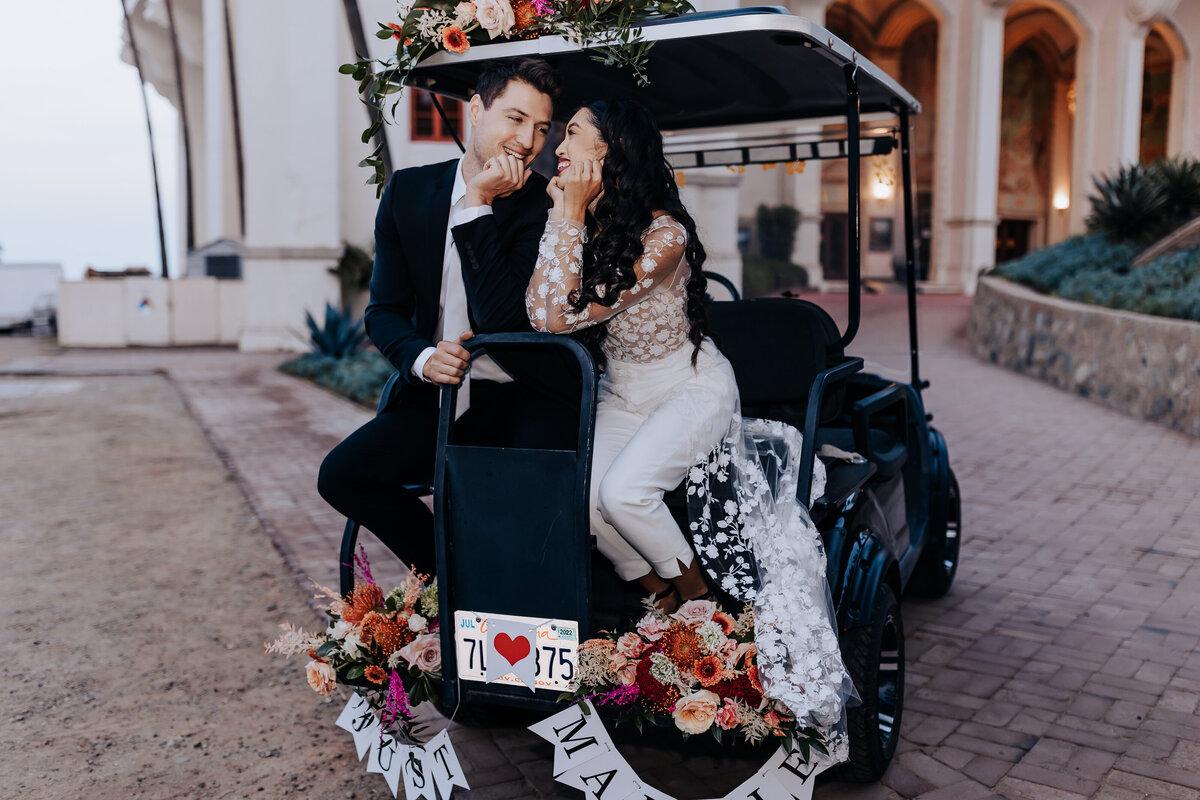 Destination elopement photographer captures couple kissing on golf cart