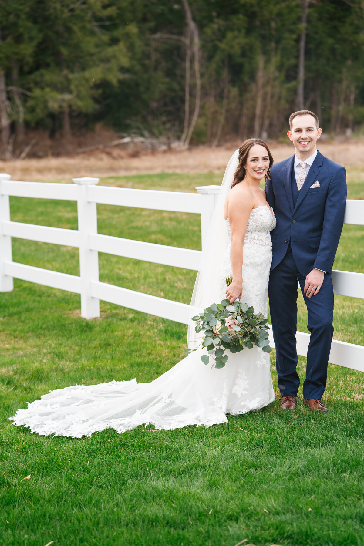 First look between bride and groom on a tree-lined path