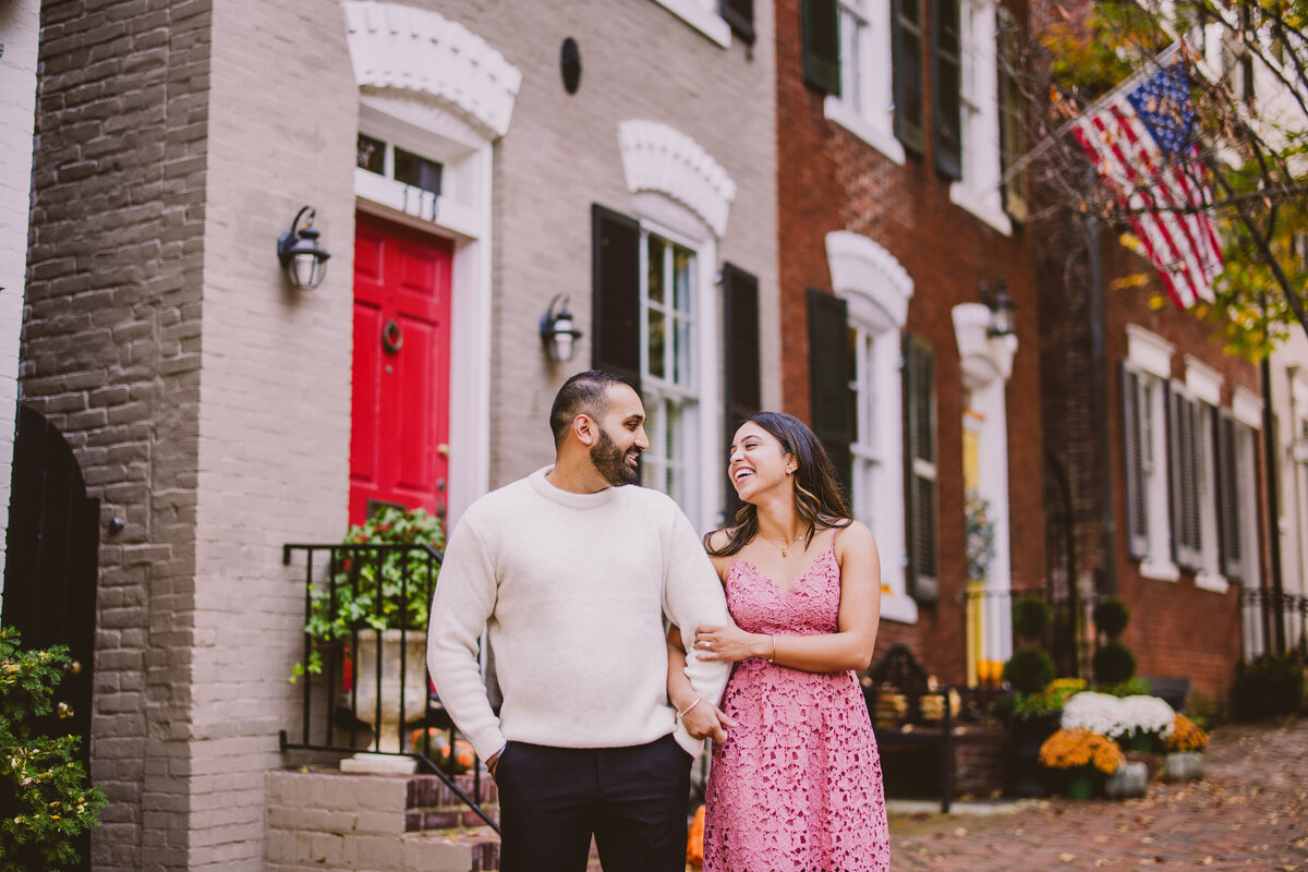 A couple sharing a moment in front of apartments in alexandria old town in the dmv