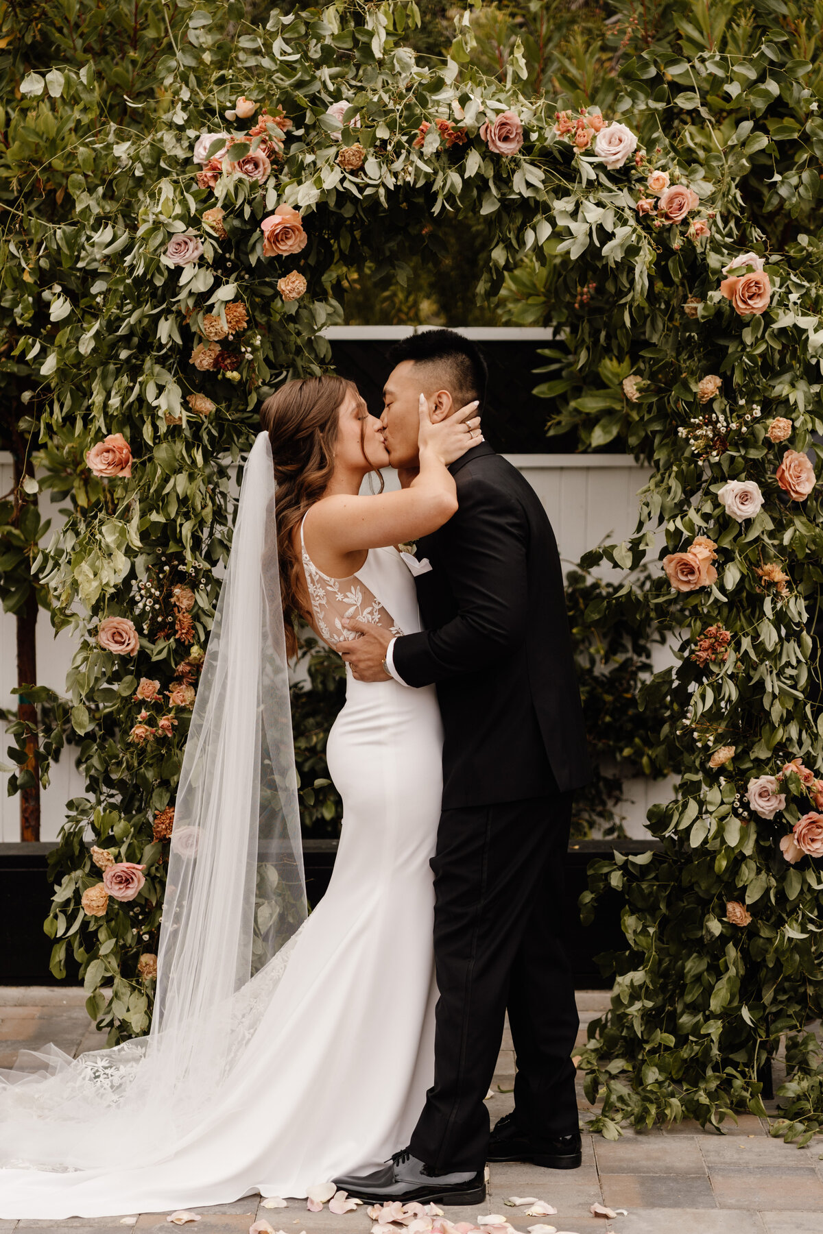 bride and groom first kiss on wedding day