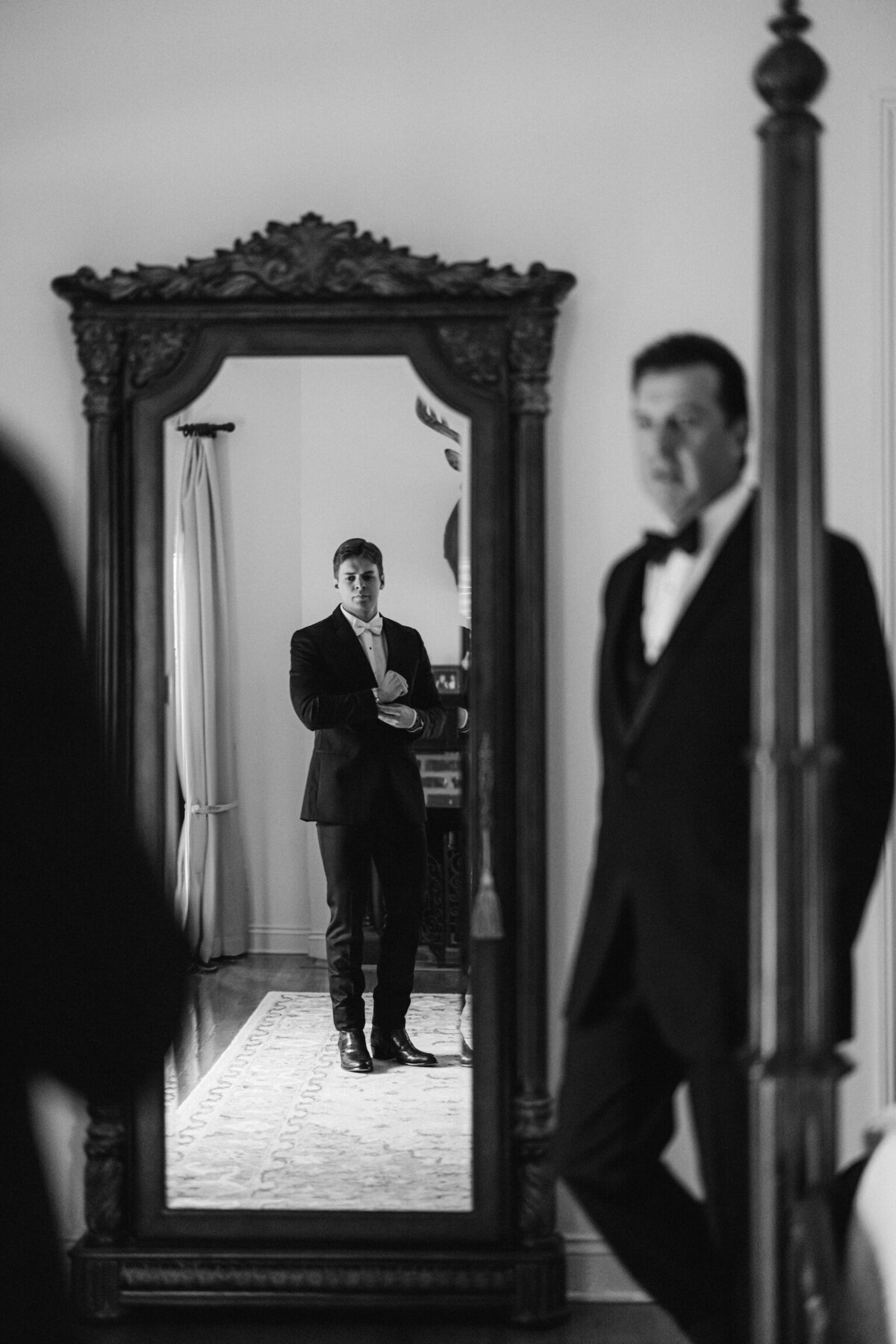 A heartfelt moment as the groom and his father share in the preparation for the wedding day, capturing a bond of love and tradition on film by Morgan Alysse, Louisiana film photographer.