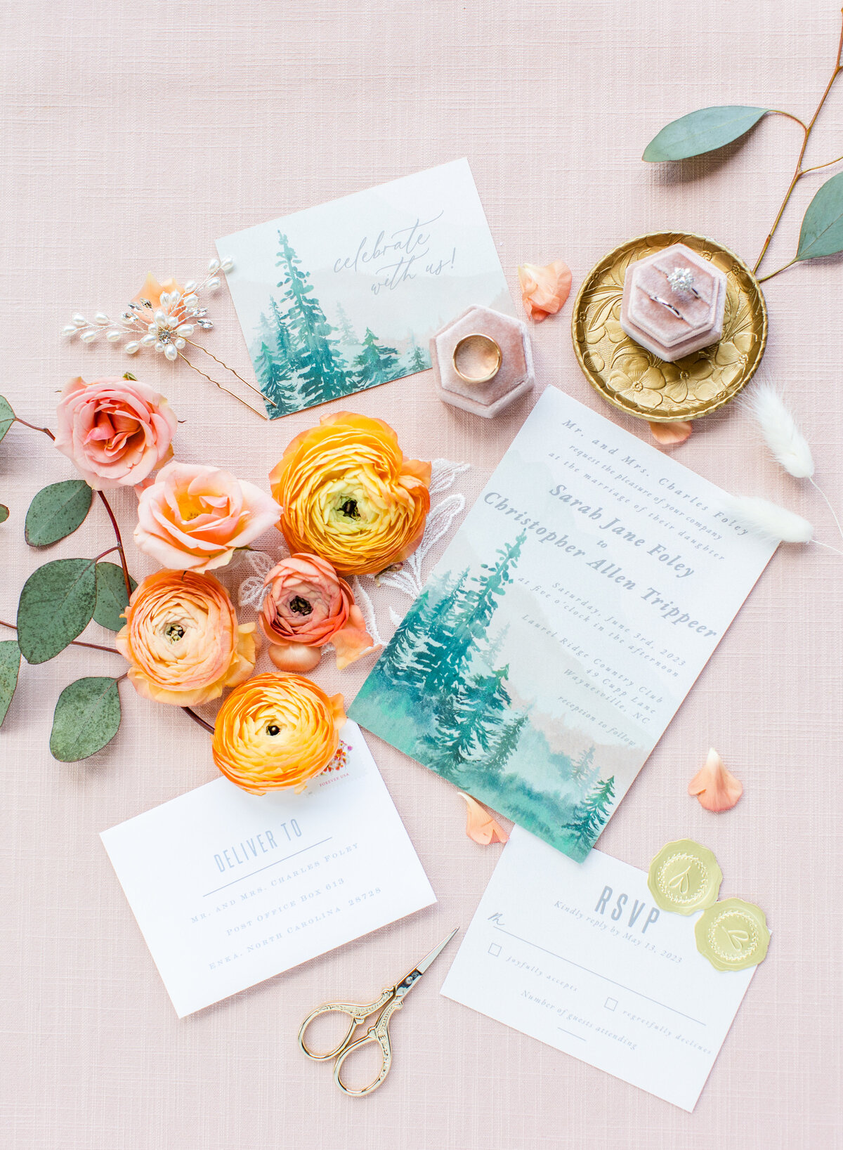 flat lay with invitation suite with green and coral colors