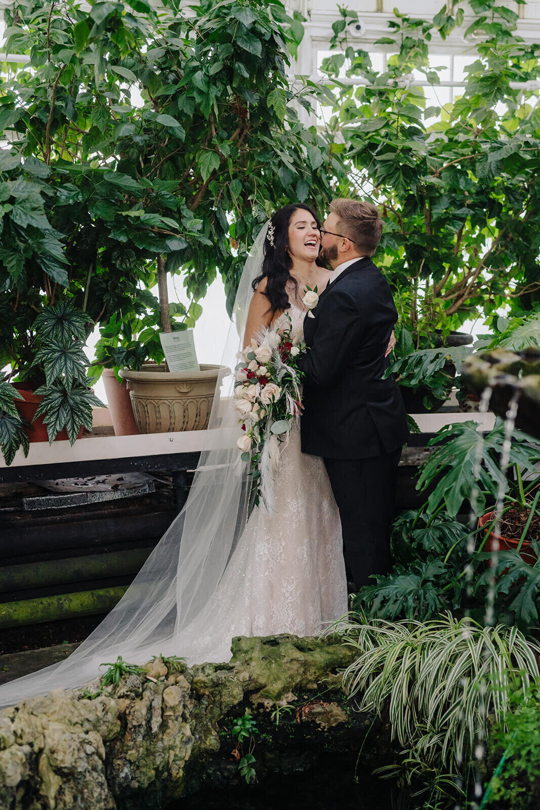 Bride and groom amongst green foliage, Finger Lakes wedding, NY