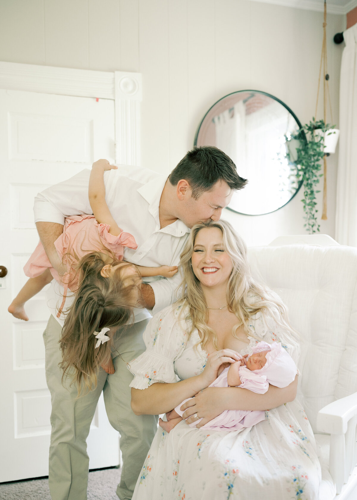 Mom and dad holding baby with toddler sister in Williamsburg Virginia Newborn Photography Session