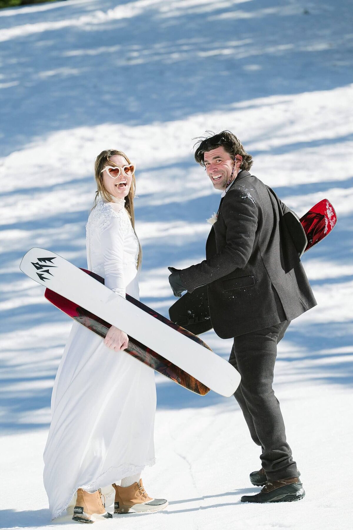 bride and groom with snowskates after eloping at Alpine in winter