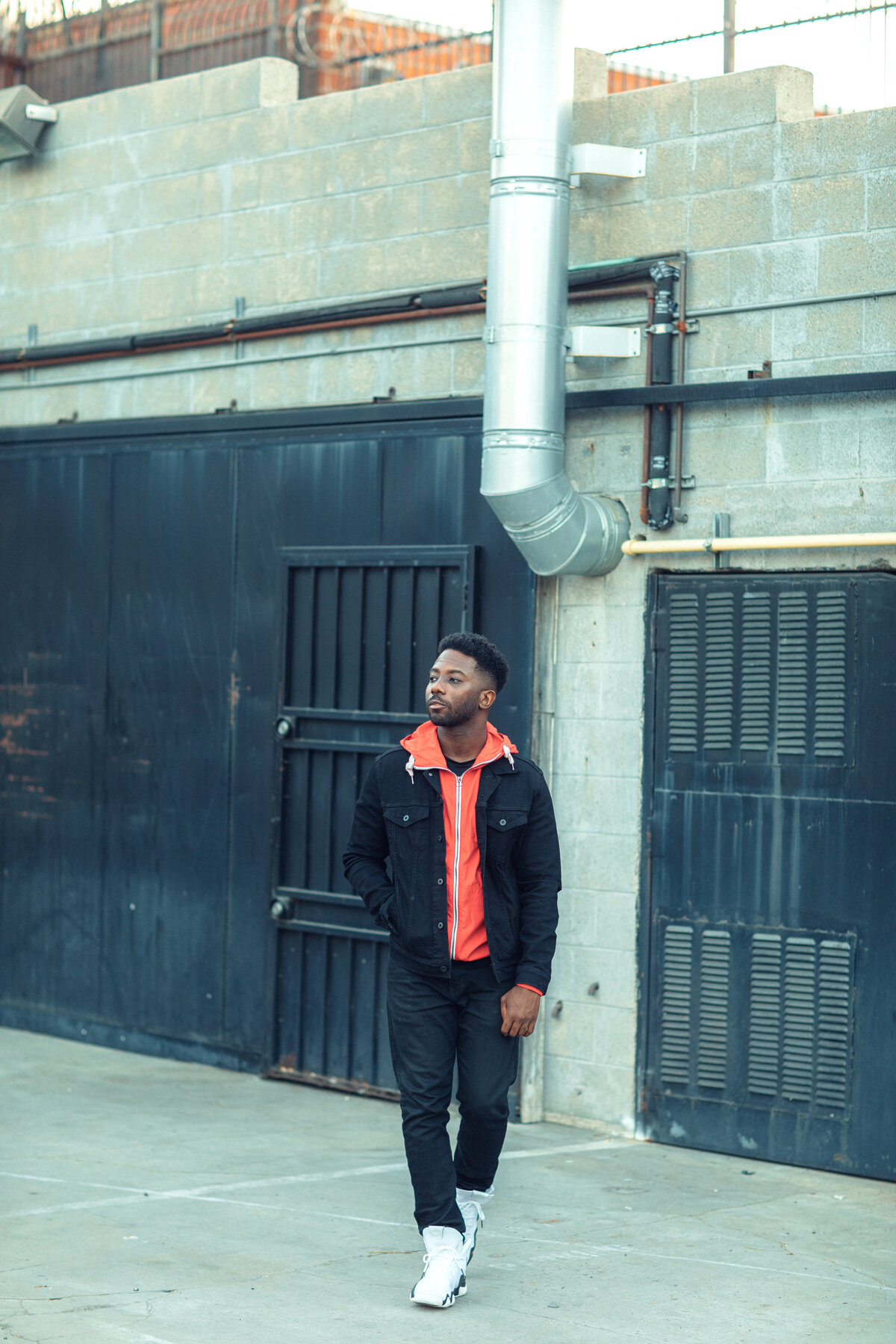 Portrait Photo Of Young Black Man In Orange Hoodie Walking Los Angeles