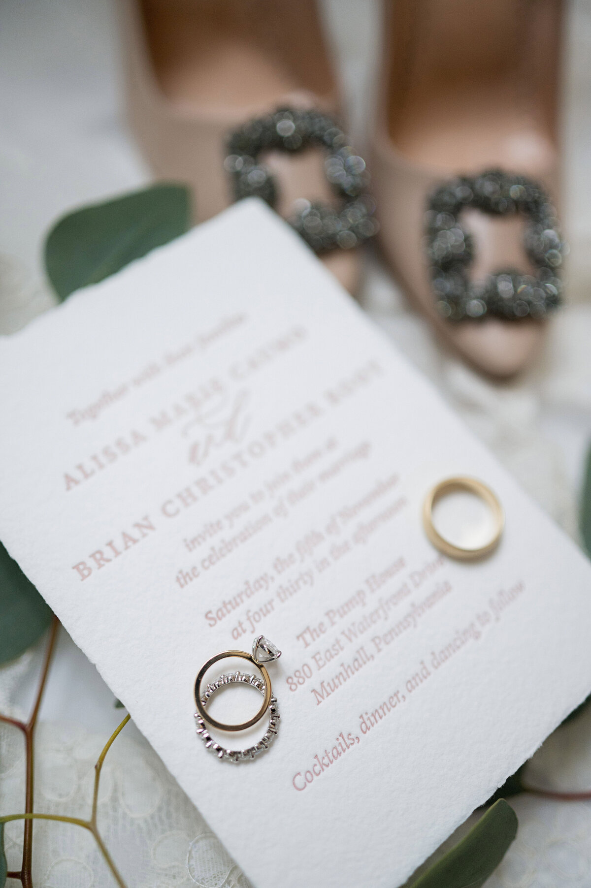 wedding rings laying on invitation