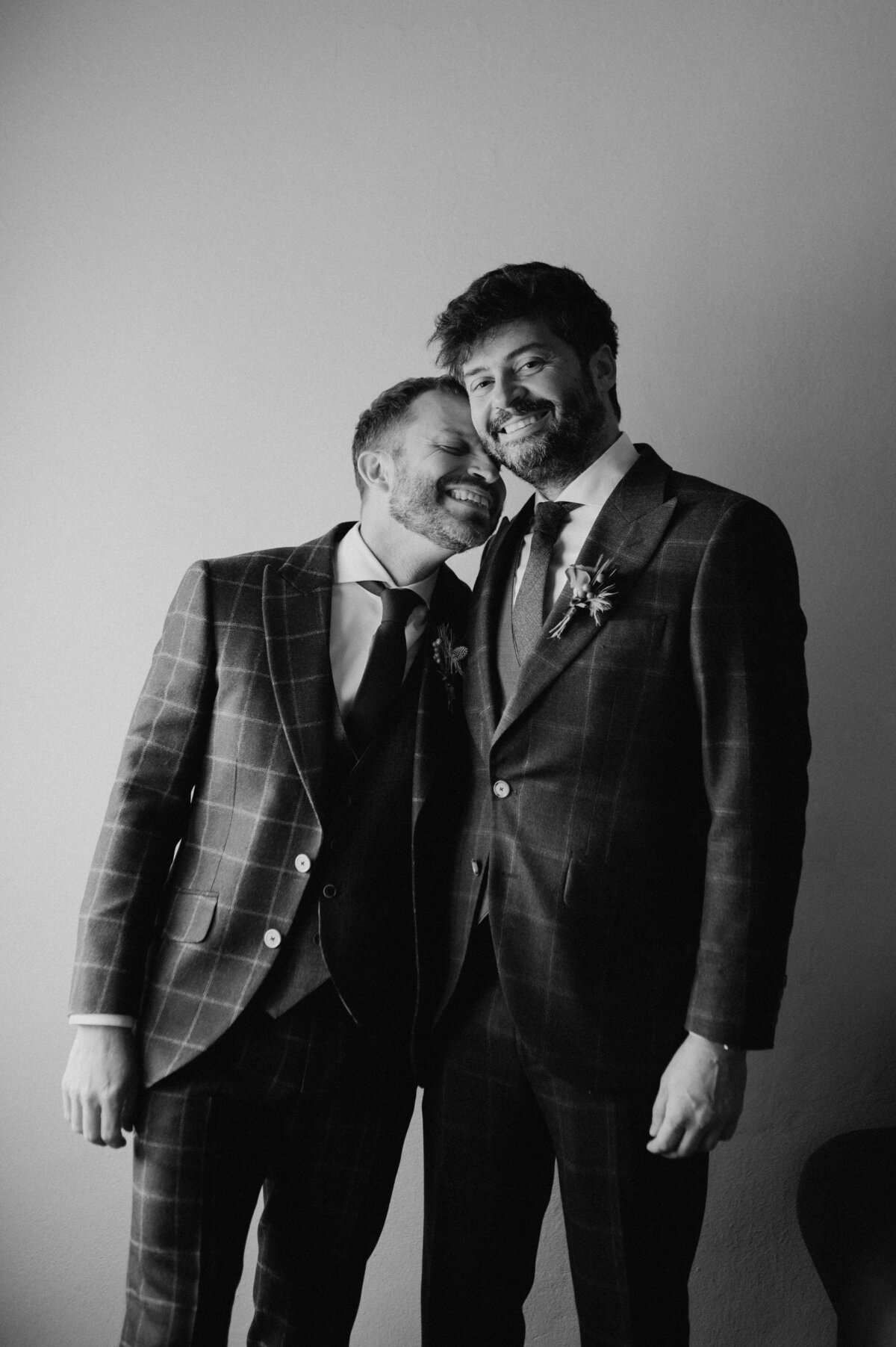 Groom and groom laughing together