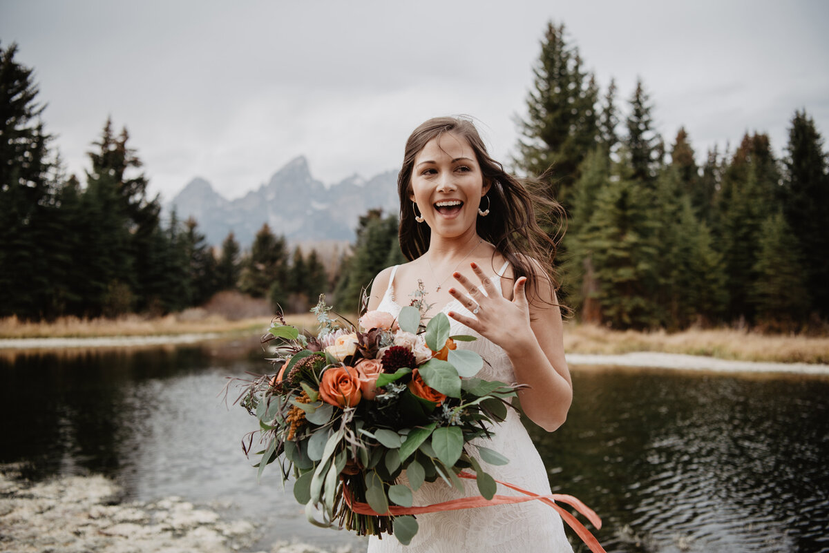 Photographers Jackson Hole capture bride showing ring and holding bouquet