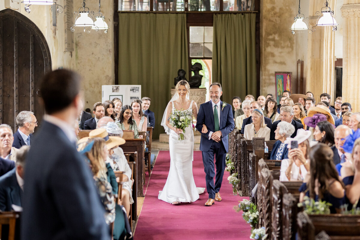 The bride walks down the aisle for her church wedding ceremony