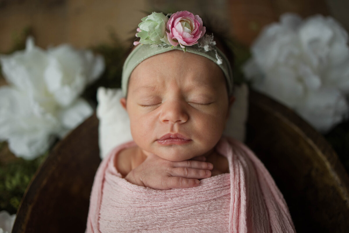 Newborn Baby Girl Wrapped in Pink With Green Headband