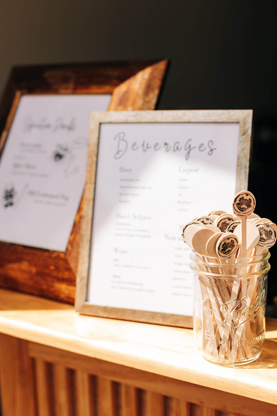A close up of a beverage sign at an outdoor wedding planned by Perfect Thirds and Co.