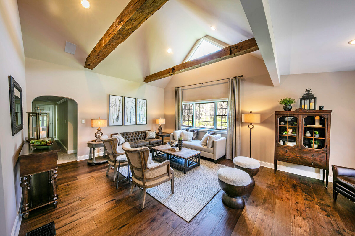 wooden beams featured in a high ceiling living room