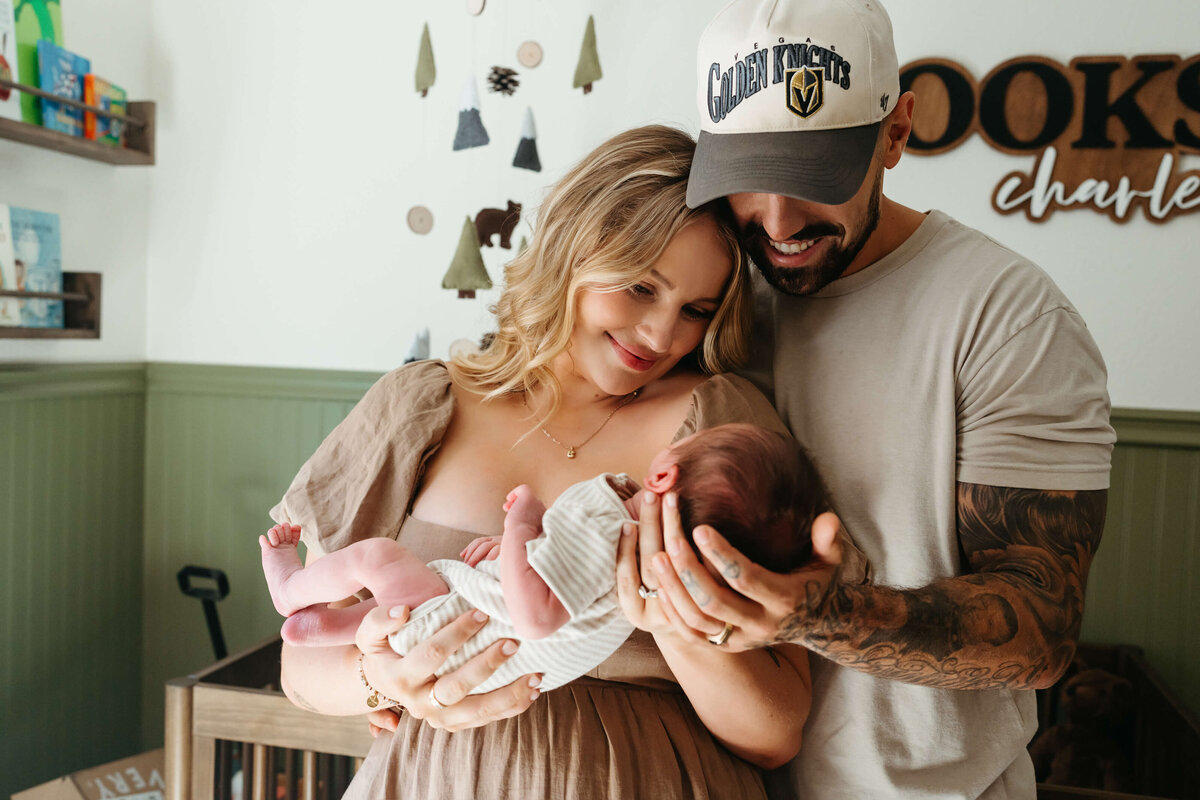 parents-holding-baby-in-nursery