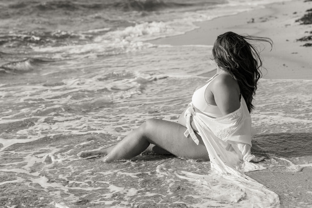 miami-maternity-beach-session-woman-sitting-in-waves-black-and-white