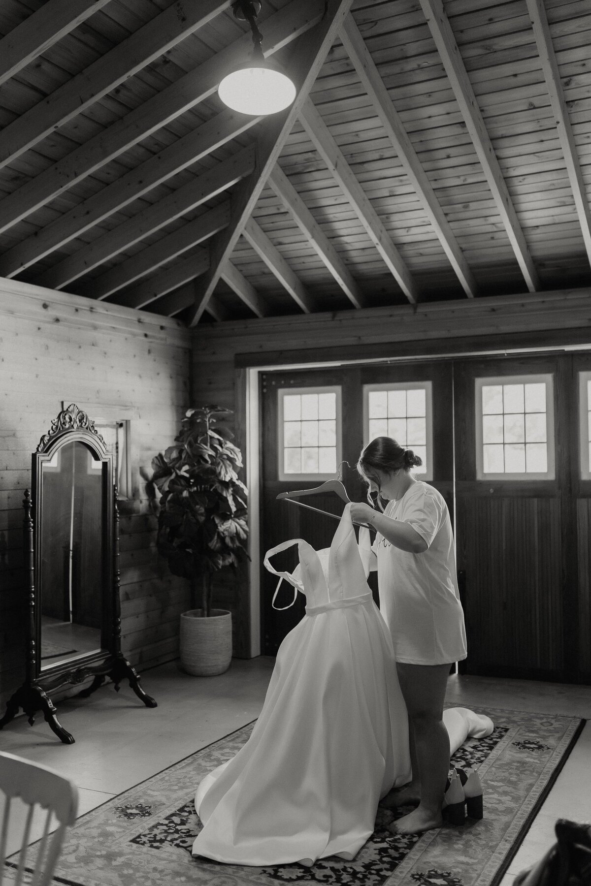 bride taking dress off hanger