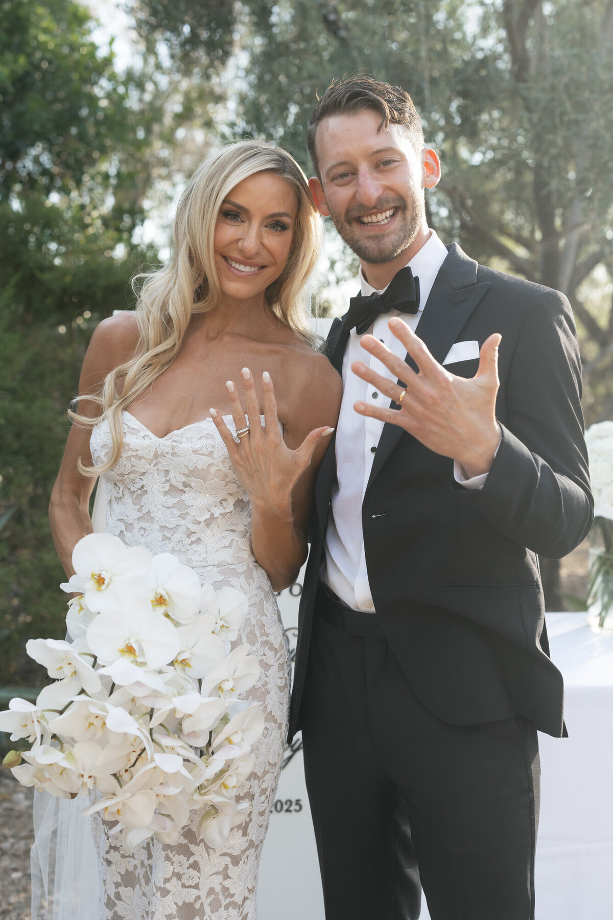 Bride and groom showing off wedding bands at El Chorro