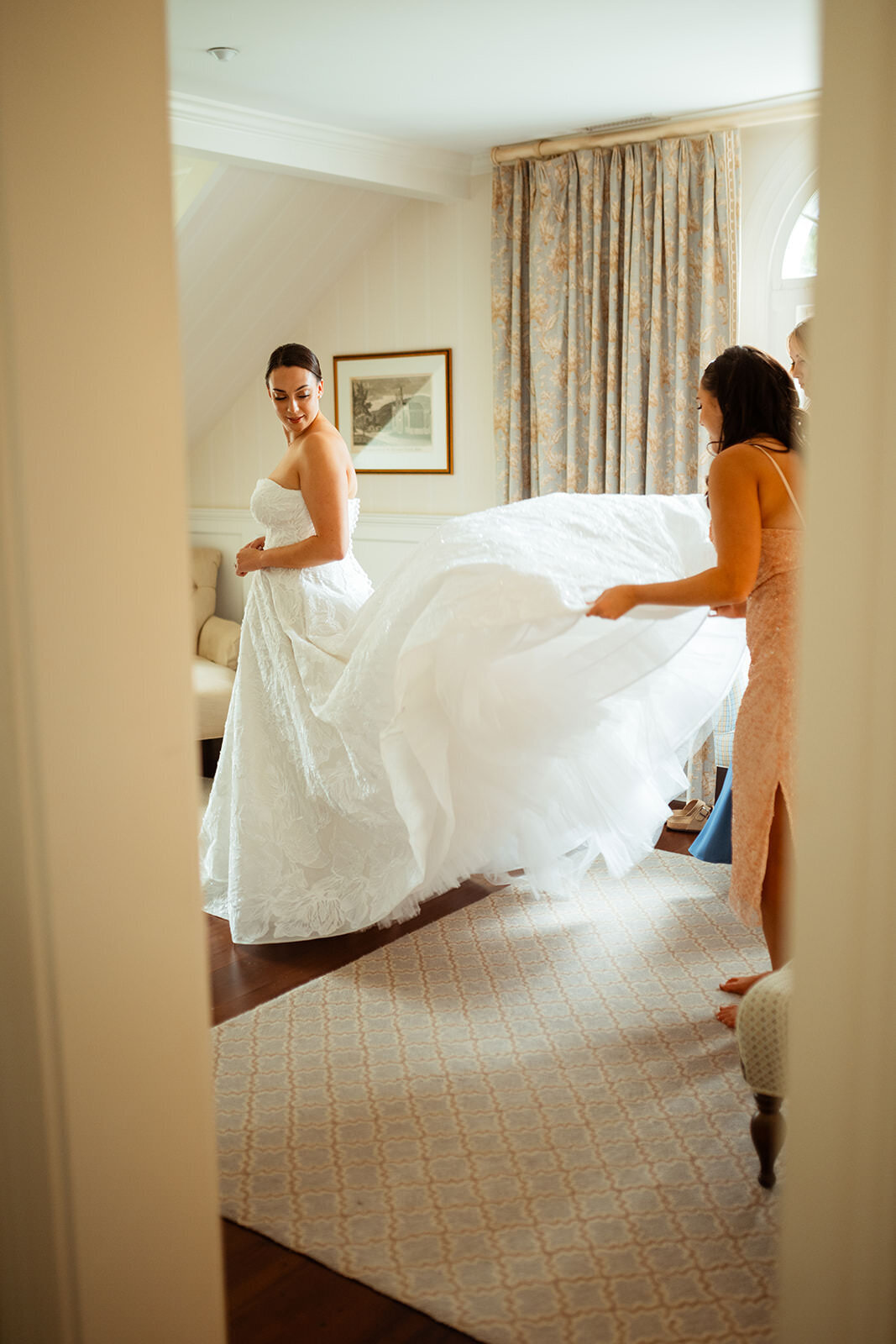 People  fluff out bride's dress train