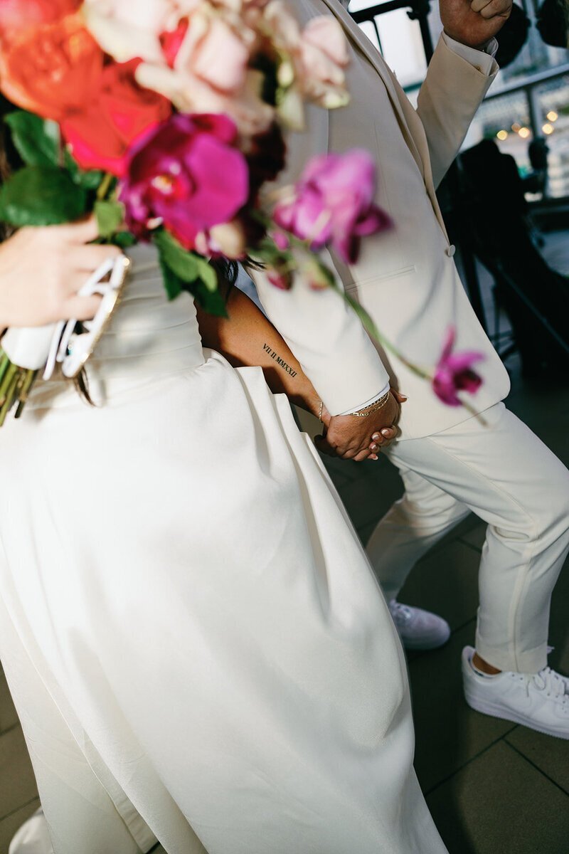 close up of bride holding flowers at the penthouse at riverside wharf​