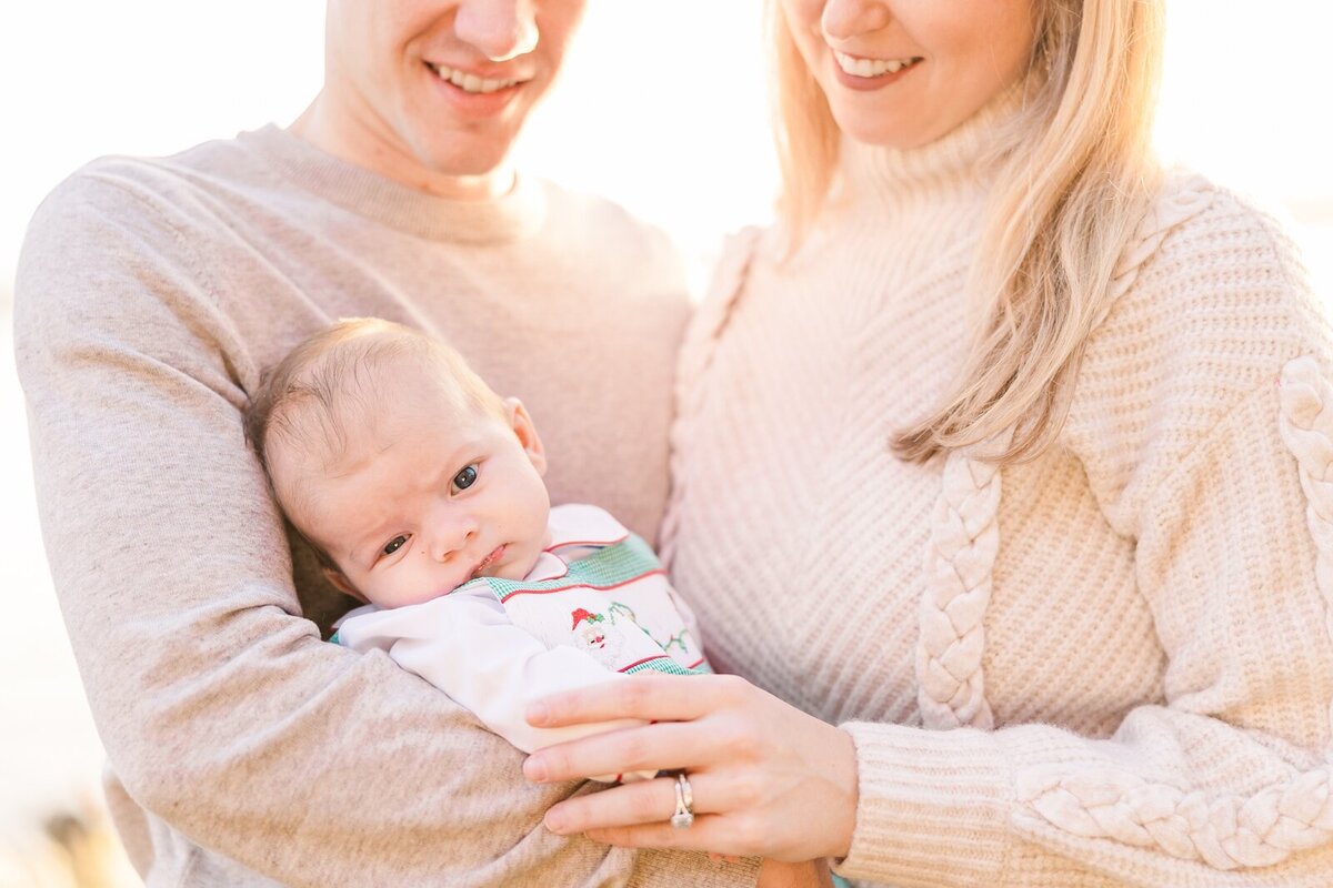 New parents smiling at their son in Founders Park in Alexandria