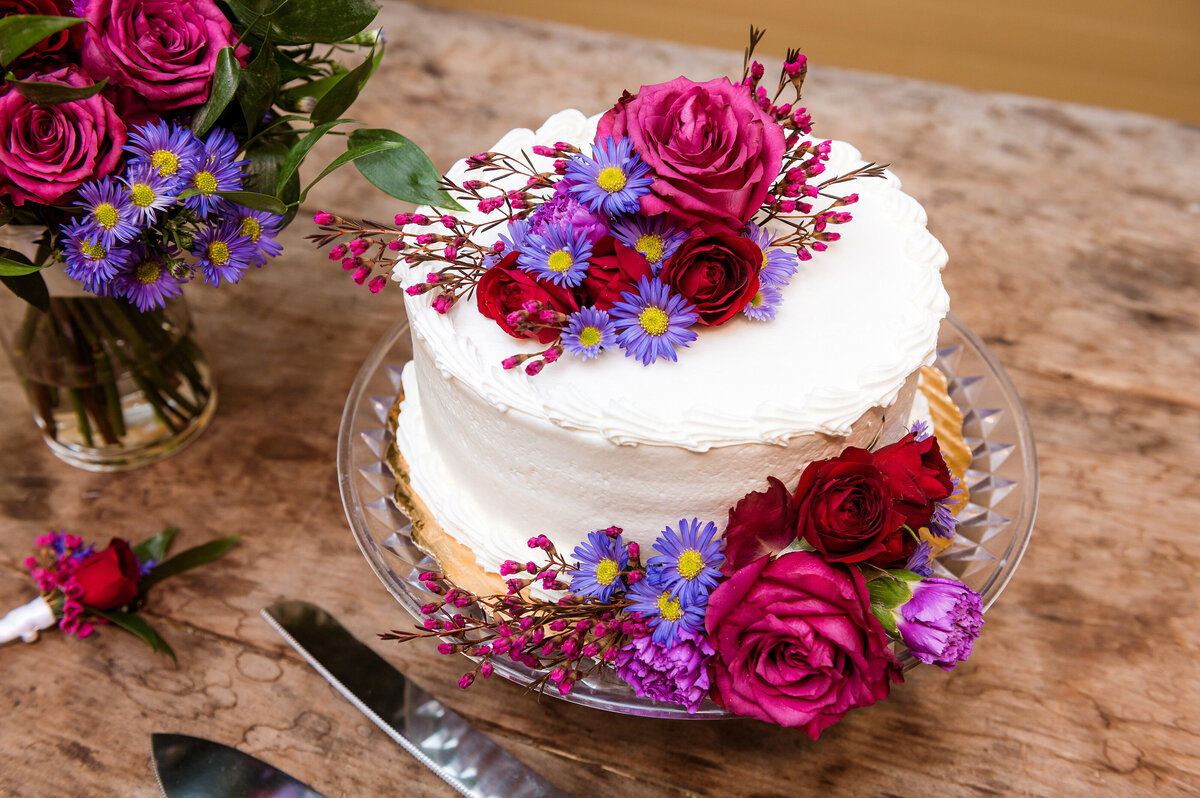 Cake with pink red and purple fall colored flowers