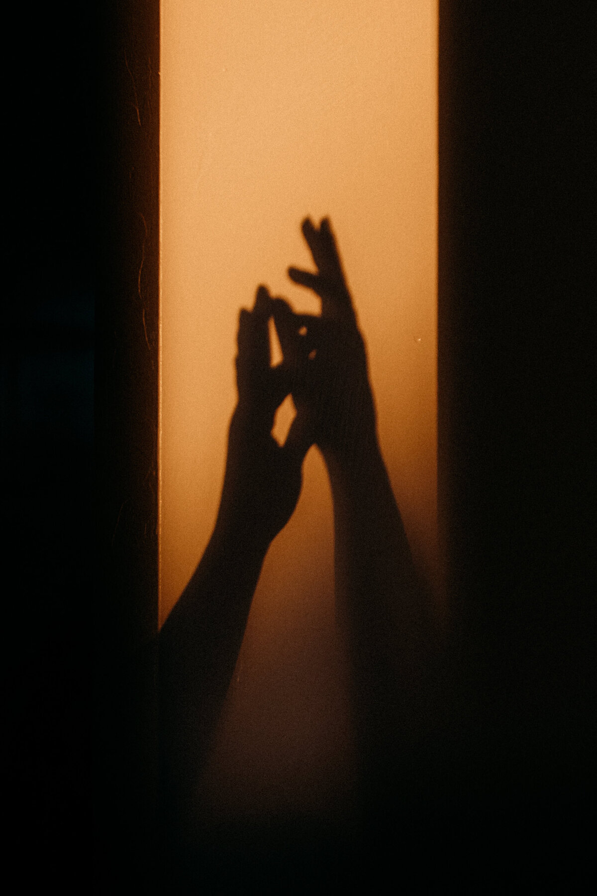 Silhouette of two hands touching