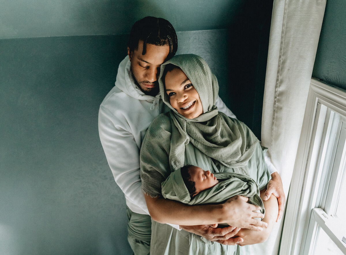 Family Photoshoot Session with dad and mom holding newborn baby.