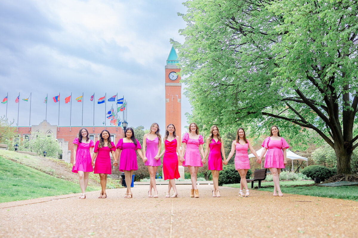 SLU delta Gamma sorority exec team holding hands at the clock tower