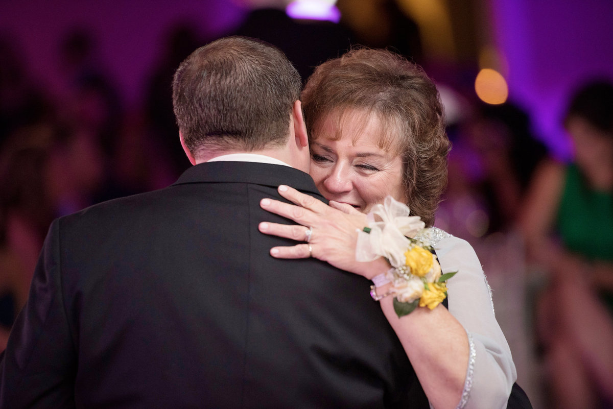 photo of mom dancing with groom during wedding reception at Lawrence Yacht and Country Club