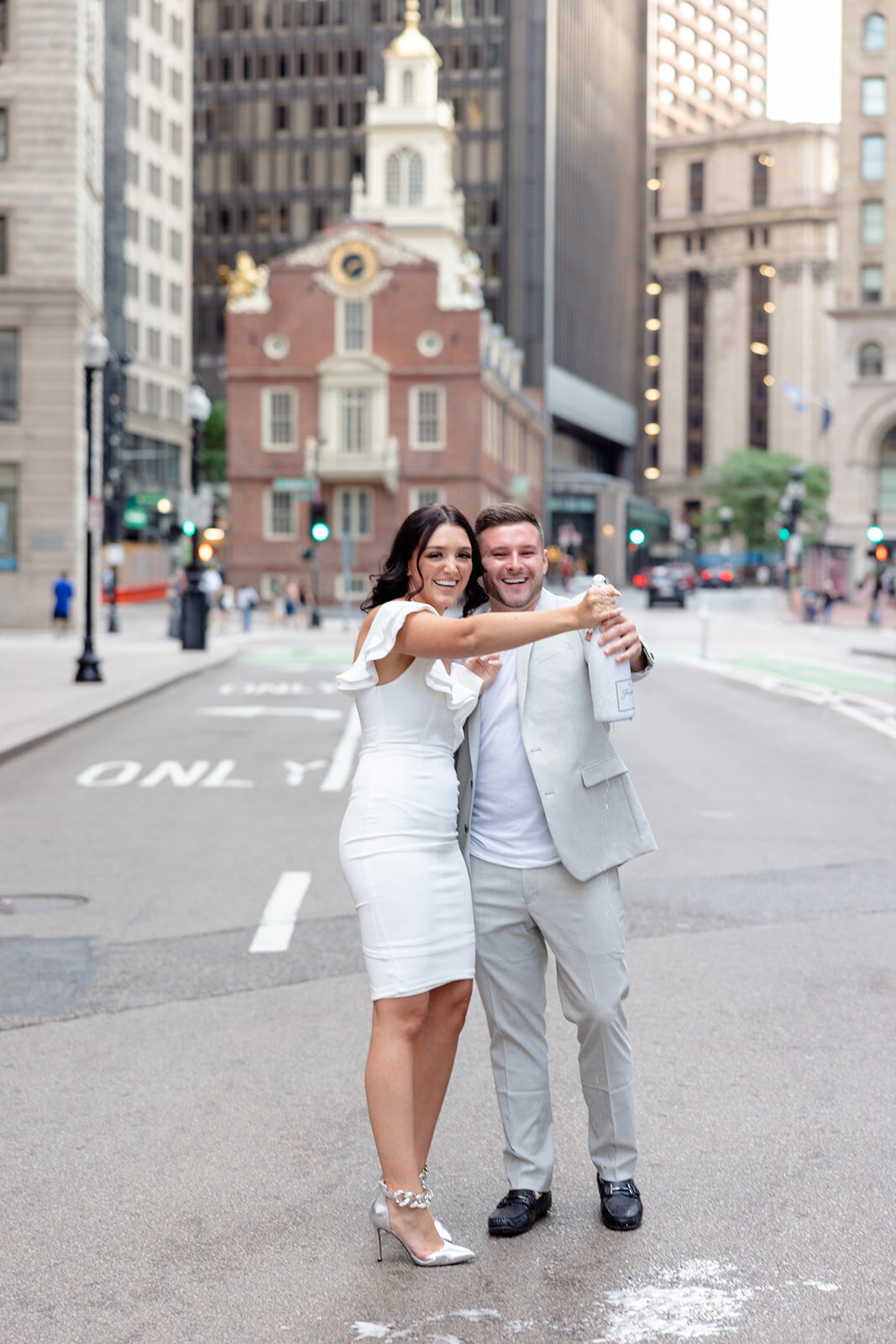 an engaged couple enjoying champagne in Boston