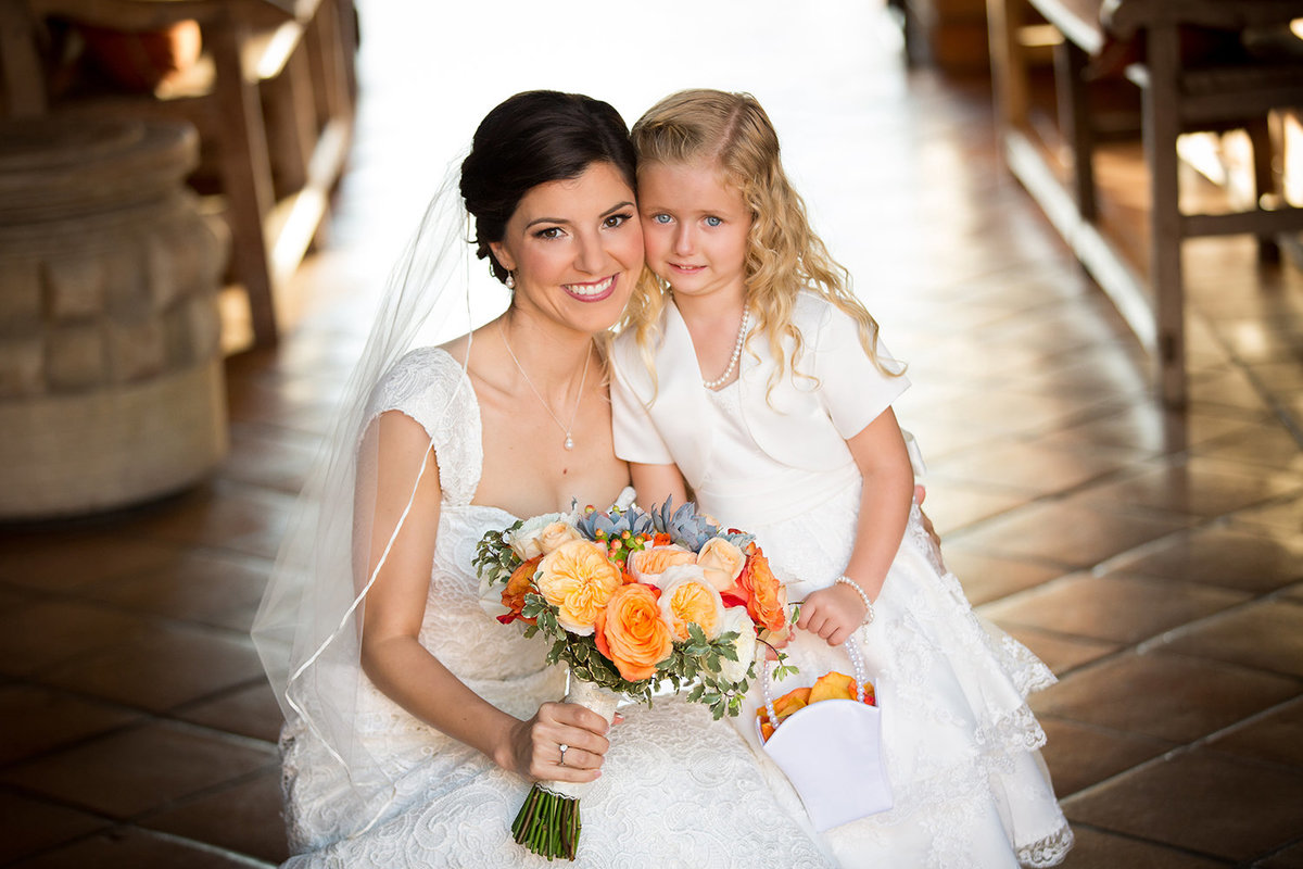 wedding photos bride with flower girl orange flowers