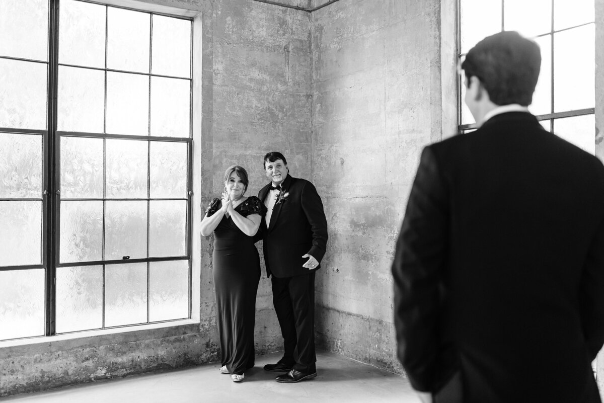 Groom having a first look with his parents in the chapel at Olde Dobbin Station.